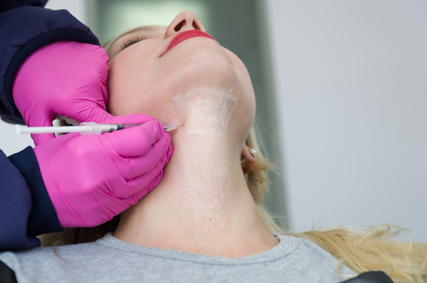 Woman having double chin cosmetically treated with Kybella